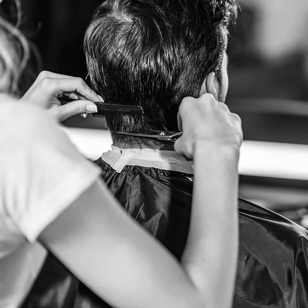 cropped-shot-of-hairdresser-cutting-hair-to-male-c-3BPSGZX